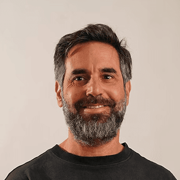 Smiling bearded man in dark shirt portrait.